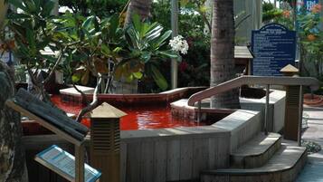 Relax by the serene pool surrounded by lush greenery and trees.