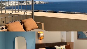 A hotel room with a balcony overlooking a coastal view, a bathroom with a sink and mirror, and a bed with multiple pillows. - Hôtel Santateresa (Bonifacio)