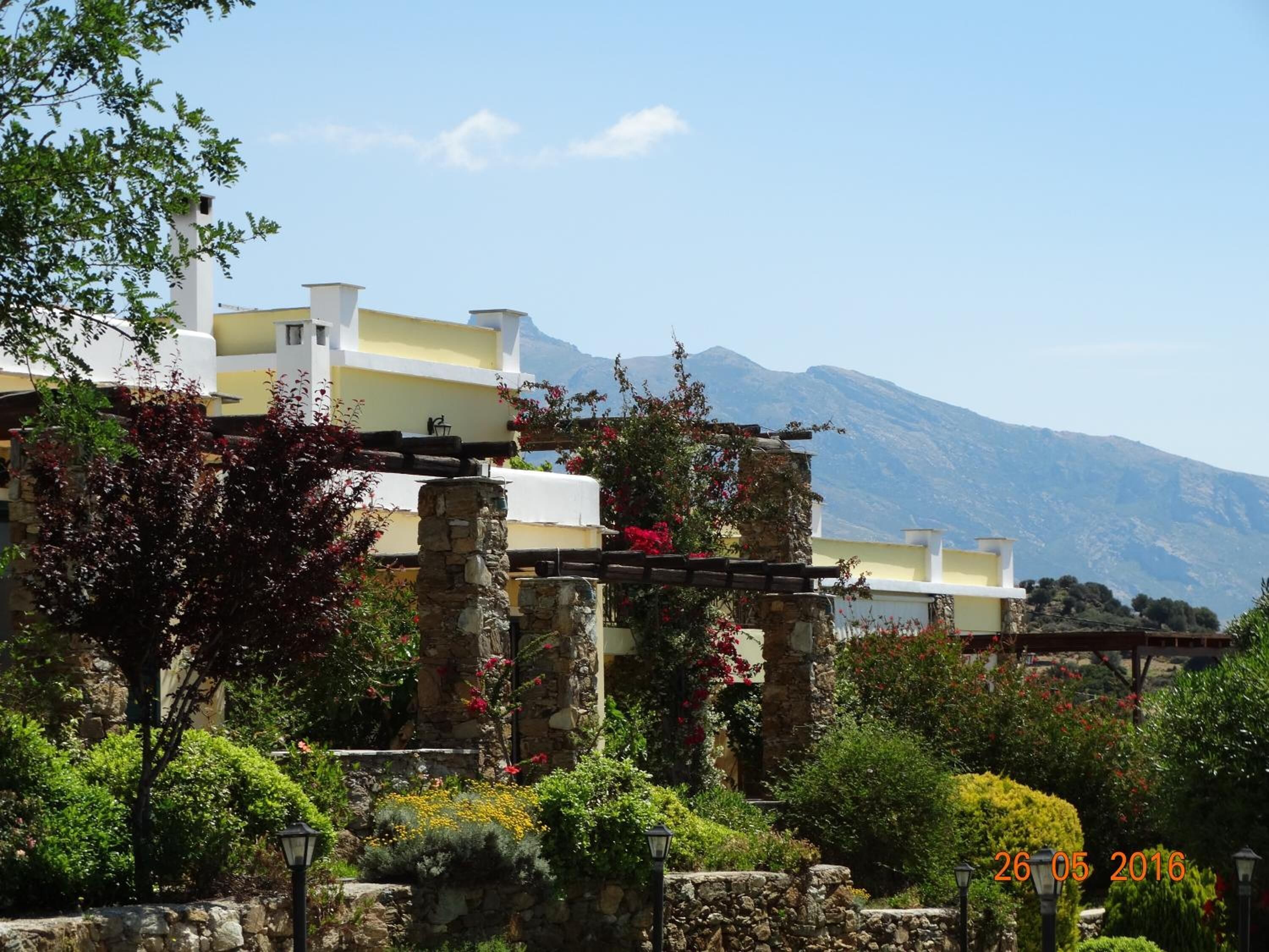 A building with a stone structure and a view of mountains in the background.