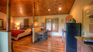 A cozy room with a bed, a small table, and a refrigerator. - Vacation Cottage in Premier Resort (Boone)