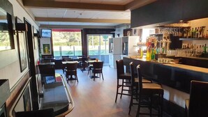 A restaurant with a bar area, tables, and chairs. - Les Pelouses (Cucq)