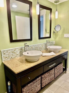 A bathroom with two sinks, a mirror, and a towel on the counter. - Spectacular view, Big corner balcony, Lagoon pool, Baytowne & free shuttle (Miramar Beach)
