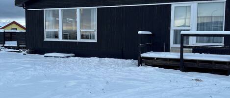 A building with a sign reading 'ALBERT GUESTHOUSE' in a snowy environment.