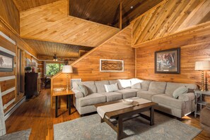 A wooden interior with a sofa, coffee table, and a dining area. - Peaceful Boone Log Cabin | Mountain Views, Fireplace, Loft & Pet Friendly (Boone)