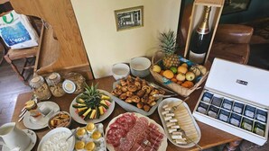 A breakfast buffet with various food items, including pastries, fruits, and meats. - Lodge Hôtel Domaine De Sommedieue (Sommedieue)