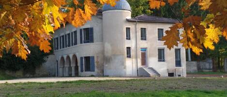 A historic building with a central dome, arched windows, and a symmetrical facade.