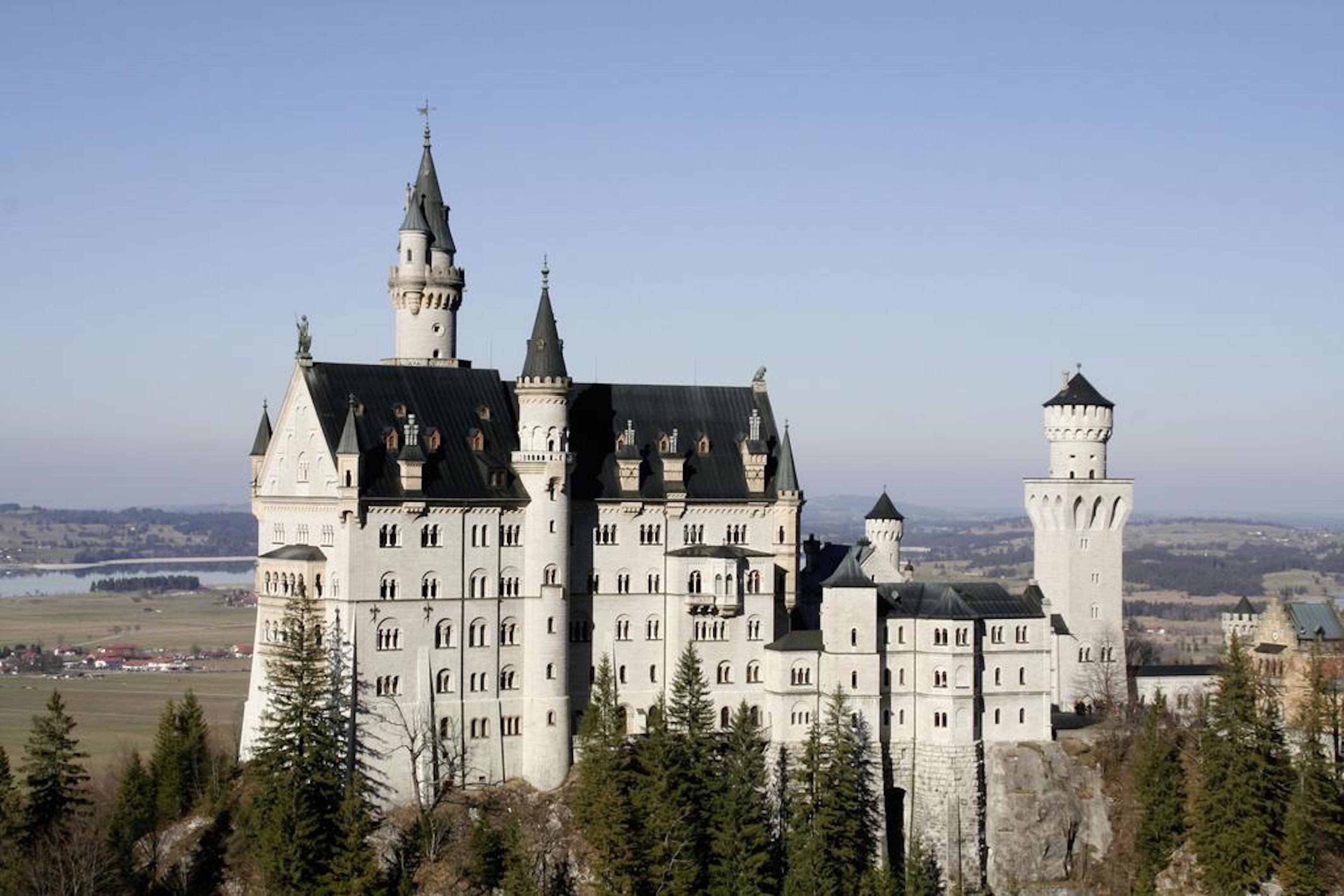 A large, historic castle with multiple towers and a prominent central building.