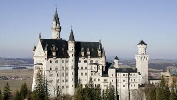 A large, historic castle with multiple towers and a prominent central building.
