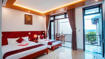 Deluxe Triple Room, Balcony, Garden View | Premium bedding, minibar, individually decorated, individually furnished
