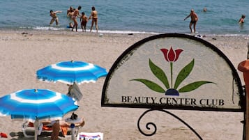 On the beach, white sand, sun-loungers, beach umbrellas