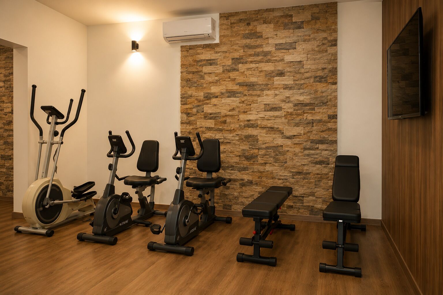 A home gym with stationary bikes, a treadmill, a bench, and a TV mounted on the wall.