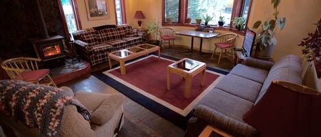 A cozy living room with a fireplace, a dining area, and comfortable seating.