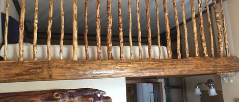 A wooden staircase with a rustic design, featuring vertical wooden slats and a natural wood finish.