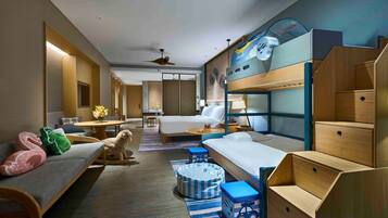 Una habitación de hotel moderna con una cama litera, un sofá, una mesa de comedor y una pequeña cocina.