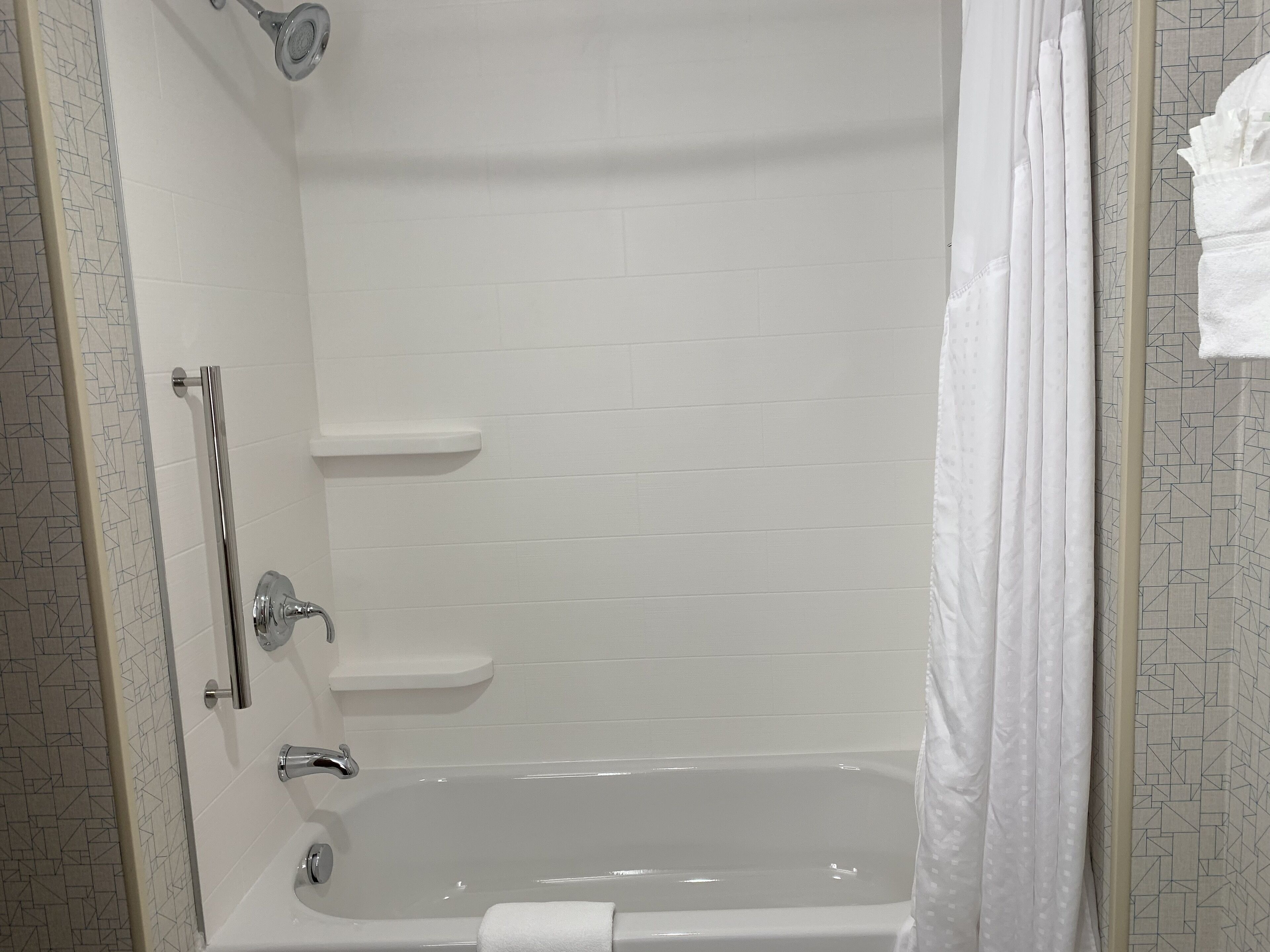 A bathroom with a bathtub, a shower area, and a toilet.