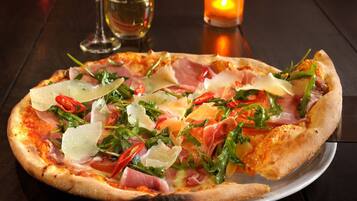 A pizza with various toppings on a white plate.