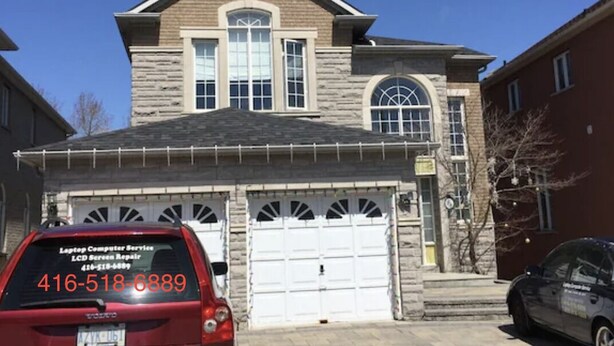 A two-story house with a garage, a red car parked in front, and a black car parked to the right. - Walkout Ravine, Cottage feeling basement (Richmond Hill)