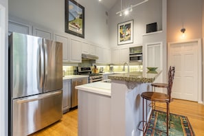 Enjoy cooking in this well-lit kitchen with a central island and stainless steel appliances.
