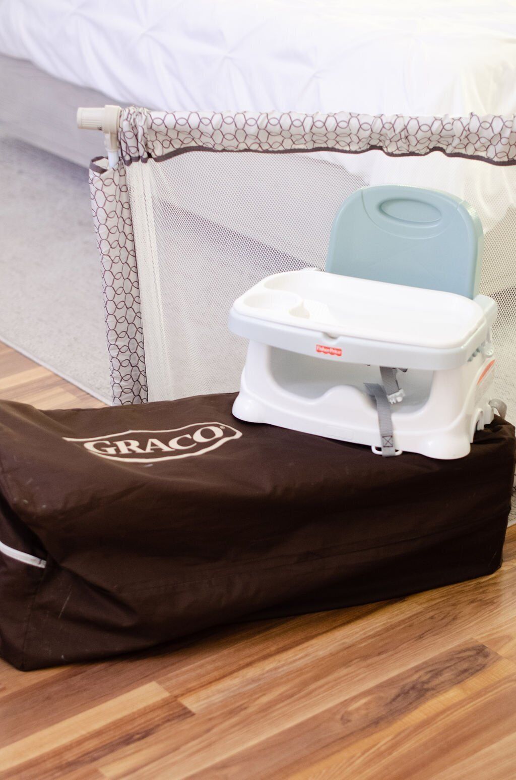 A portable potty on a brown bag with the brand "GRACO" visible.