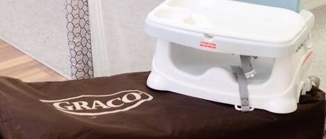 A portable potty on a brown bag with the brand "GRACO" visible.