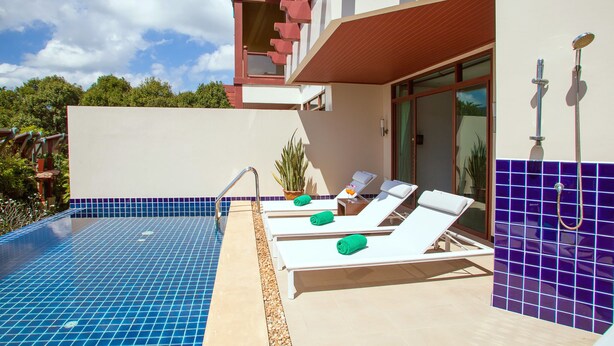 A modern pool area with lounge chairs and a shower. - Amatapura Seaview Villa 26 (Krabi)