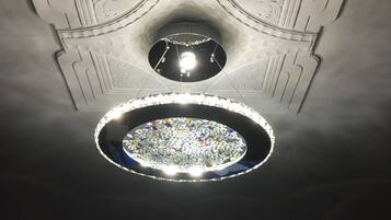A ceiling with a circular skylight and a central light fixture.