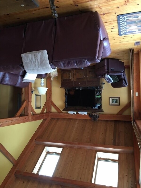 A cozy room with a leather recliner, wooden walls, a small table, and a window. - Stunning Executive, Post & Beam, Fenelon Falls/Bobcaygeon Waterfront Retreat (Kawartha Lakes)