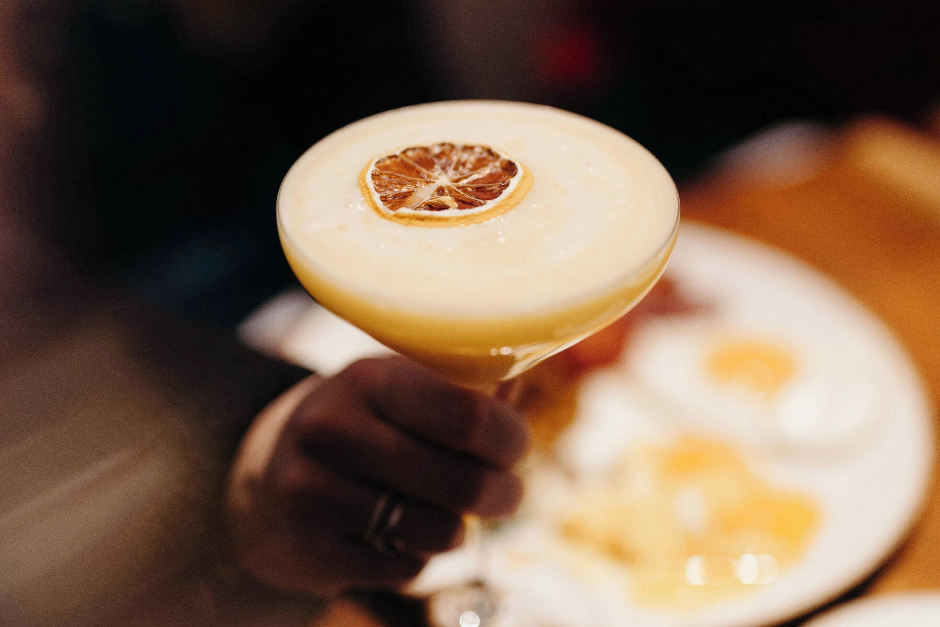 A cocktail with a garnish in a martini glass.