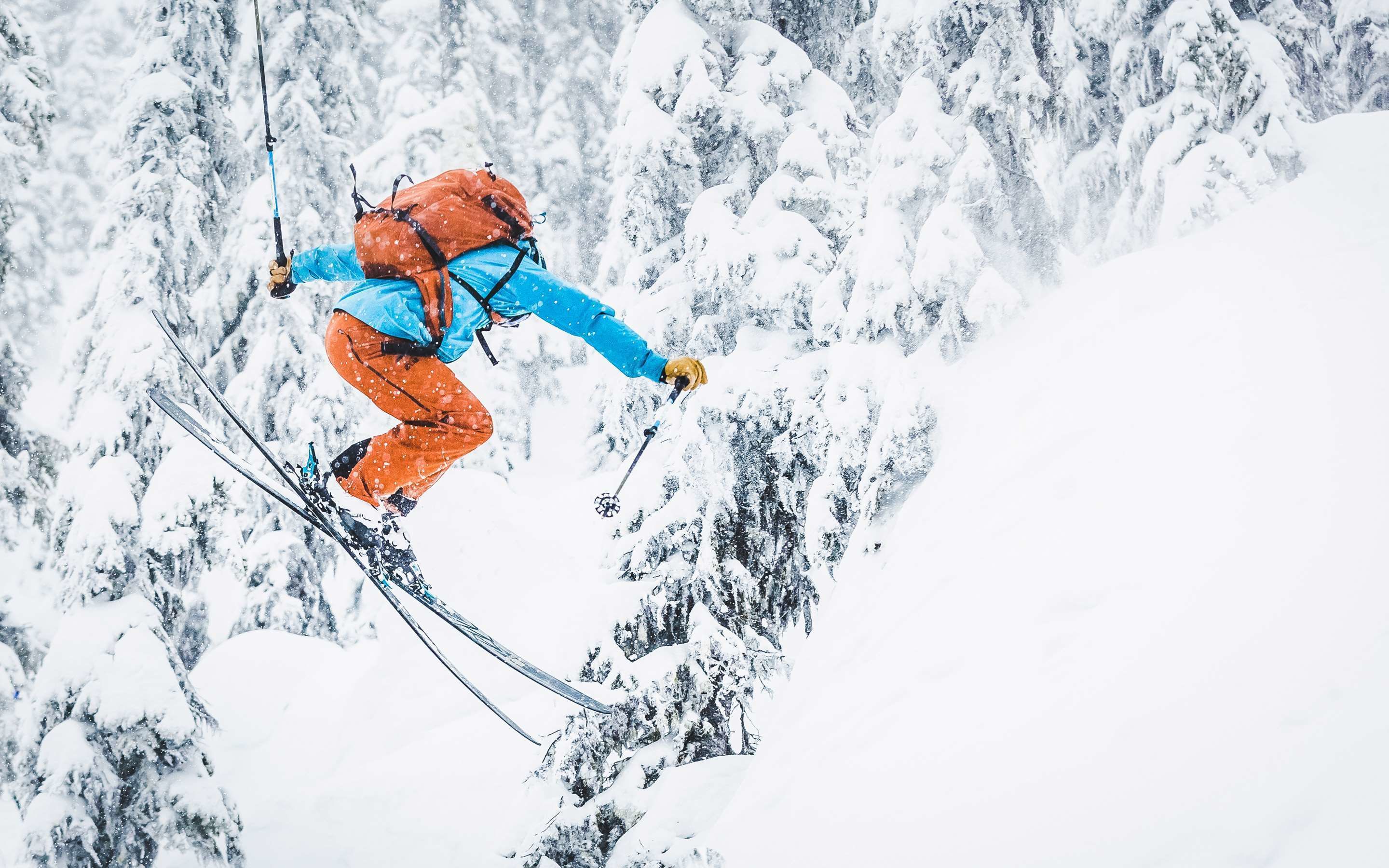 A person skiing down a snowy mountain slope.
