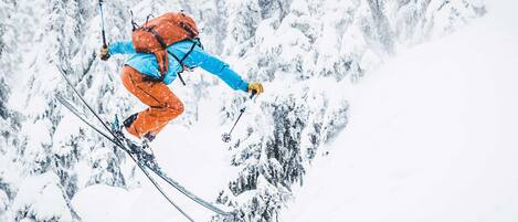 A person skiing down a snowy mountain slope.