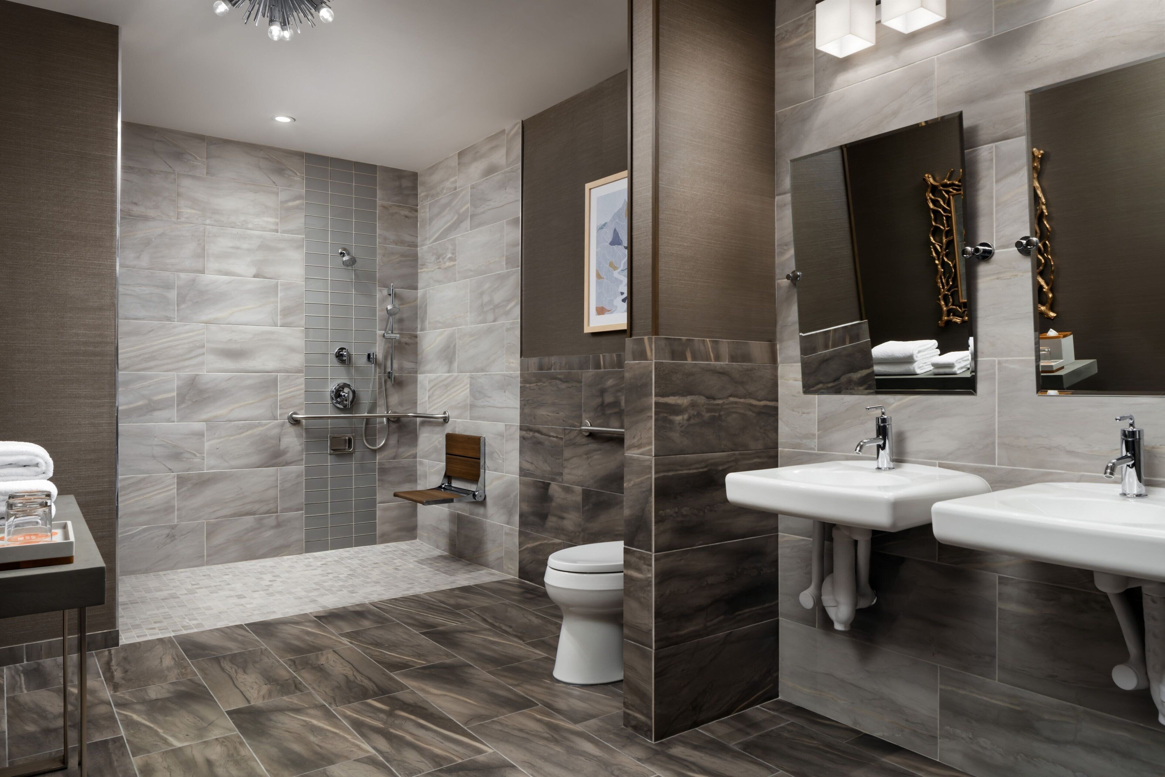 A modern bathroom with a shower, toilet, and two sinks.
