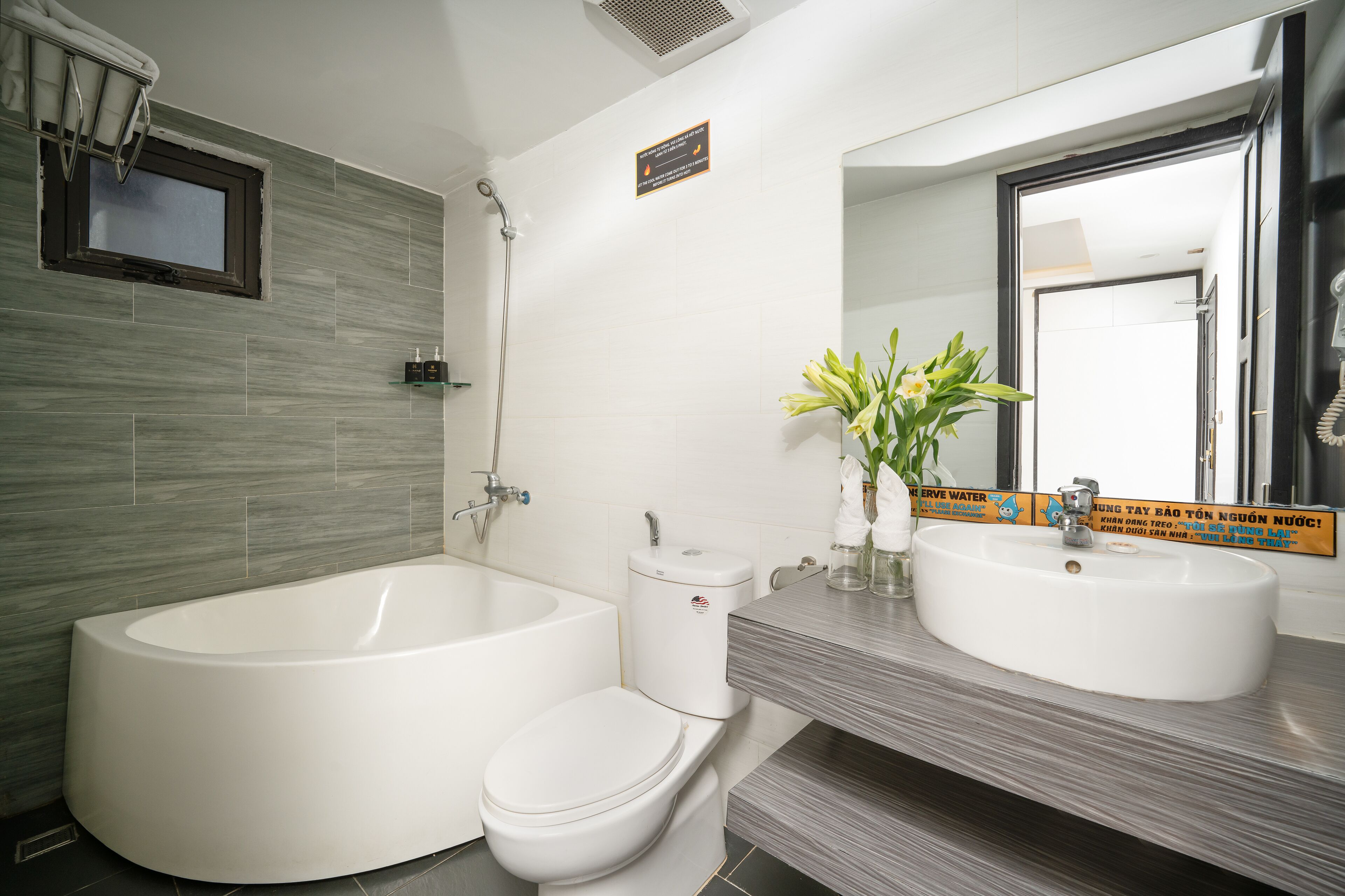 deluxe king room | bathroom | free toiletries, hair dryer, slippers, bidet