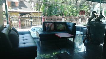 A modern living room with a sofa, a small table, and a decorative horse statue.