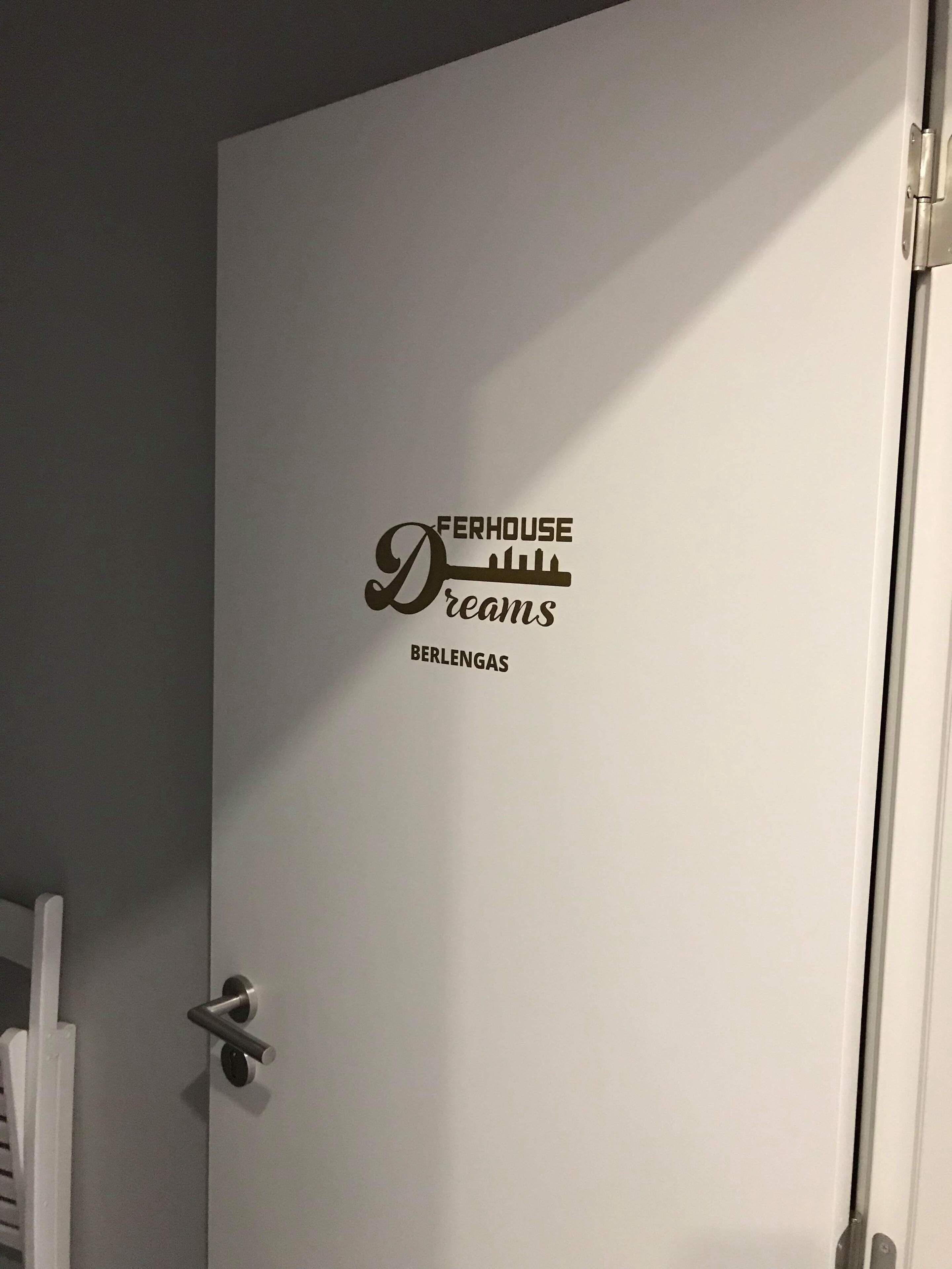 A door with a logo that reads 'FERHOUSE Dreams BERLANGAS'.