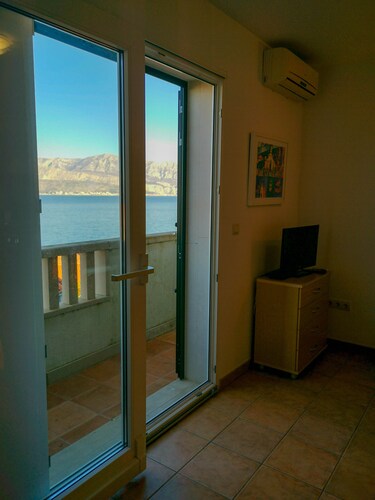 Modern studio with balcony views across the glistening Adriatic