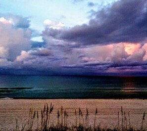 A beach with waves and tall grasses in the foreground. - Pvt Pool,Pet friendly,3 Blocks to the beach, 10 minutes to Pier Park 





 (Panama City Beach)