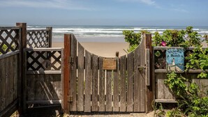 A wooden beach gate with a sign that reads "Welcome to the Beach."