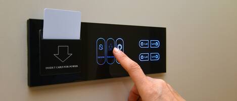 A card reader with a card inserted and a hand pointing to the buttons.