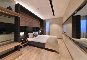 A modern hotel room with a large bed, bedside tables, a built-in TV, and a large mirror. - Nish Palace Exclusive Suites (Istanbul)