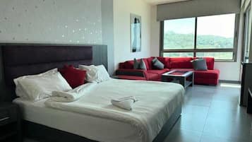 Deluxe Suite, 1 Double Bed, Balcony, Sea View | Living area | Flat-screen TV