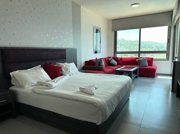 Deluxe Suite, 1 Double Bed, Balcony, Sea View | Living area | Flat-screen TV