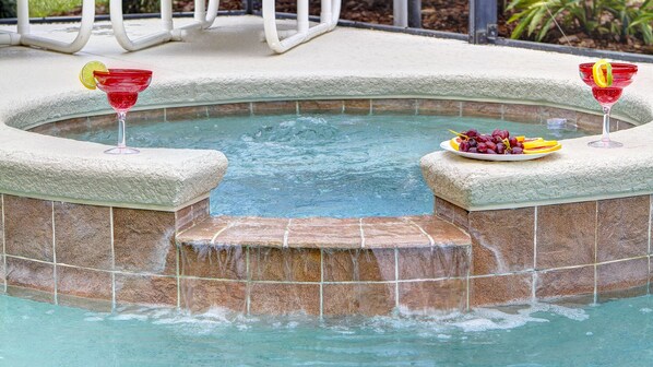 Een buitenzwembad, een verwarmd zwembad, ligstoelen bij het zwembad