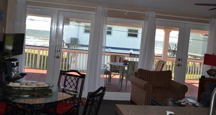 Few Steps from beach, fabulous view from ginormous gated deck!