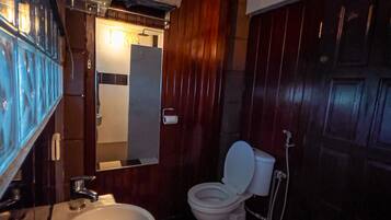 A bathroom with a checkered floor, a white toilet, a sink, and a mirror.
