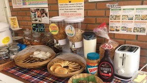 A breakfast buffet with various food items and condiments. - Hostel Lullaby - Adults Only (Chiang Mai)