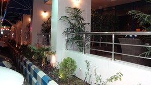 An outdoor area with a railing, potted plants, and a view of the street. - Qasr Al Sahab (Khamis Mushait)