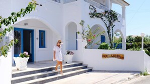 A white building with blue doors and windows, a sign reading "KAIMERA," and steps leading up to the entrance. - Kalimera Studios and Apartments (Corfu)