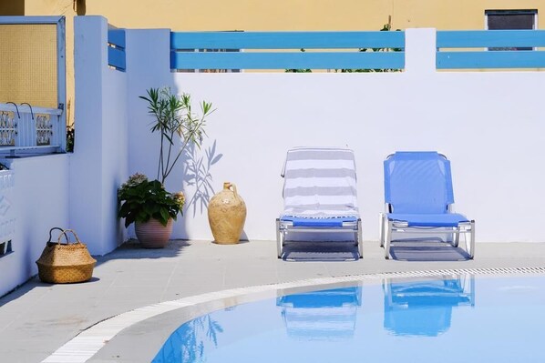 Seasonal outdoor pool, open 9:00 AM to 8:00 PM, pool umbrellas