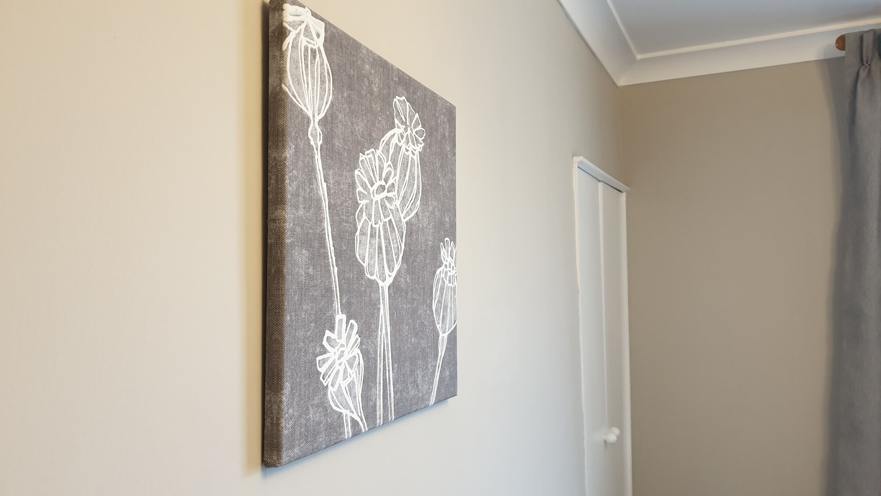 A wall-mounted artwork with a floral pattern.