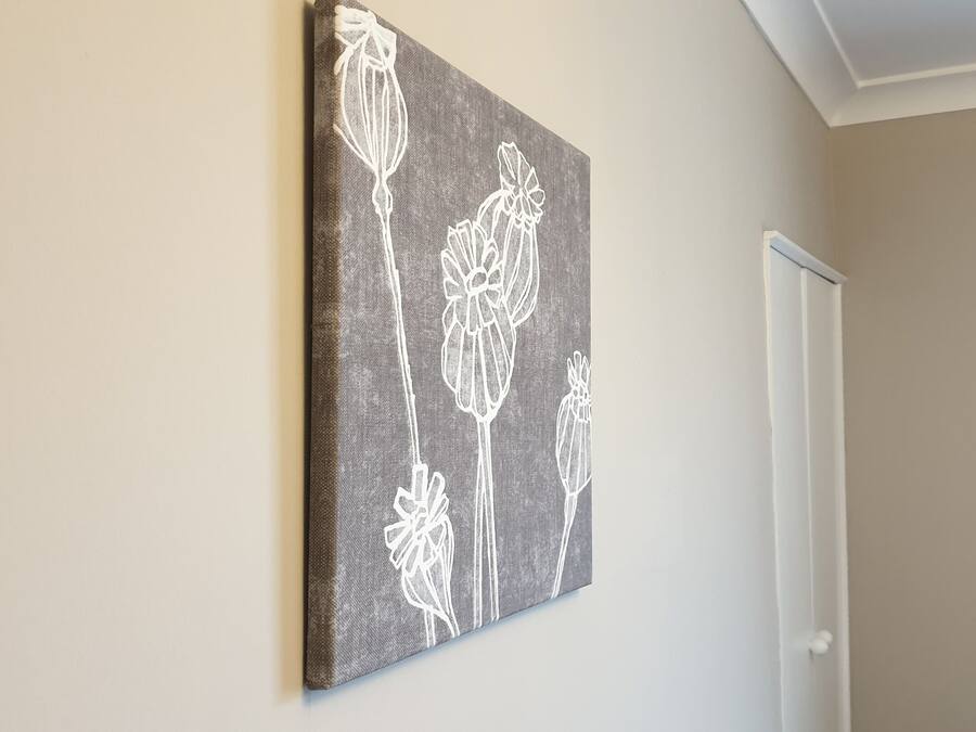 A wall-mounted artwork with a floral pattern.